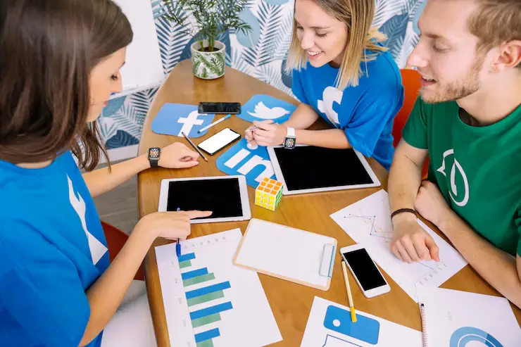 Group of people reviewing social media analytics on tablets